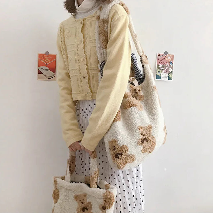 Person holding a kawaii teddy bear-themed bag against a plain background