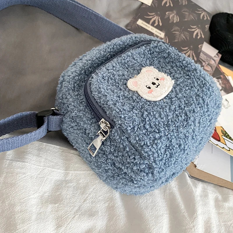 Blue fleece pouch with a Kawaii teddy bear patch on a light background
