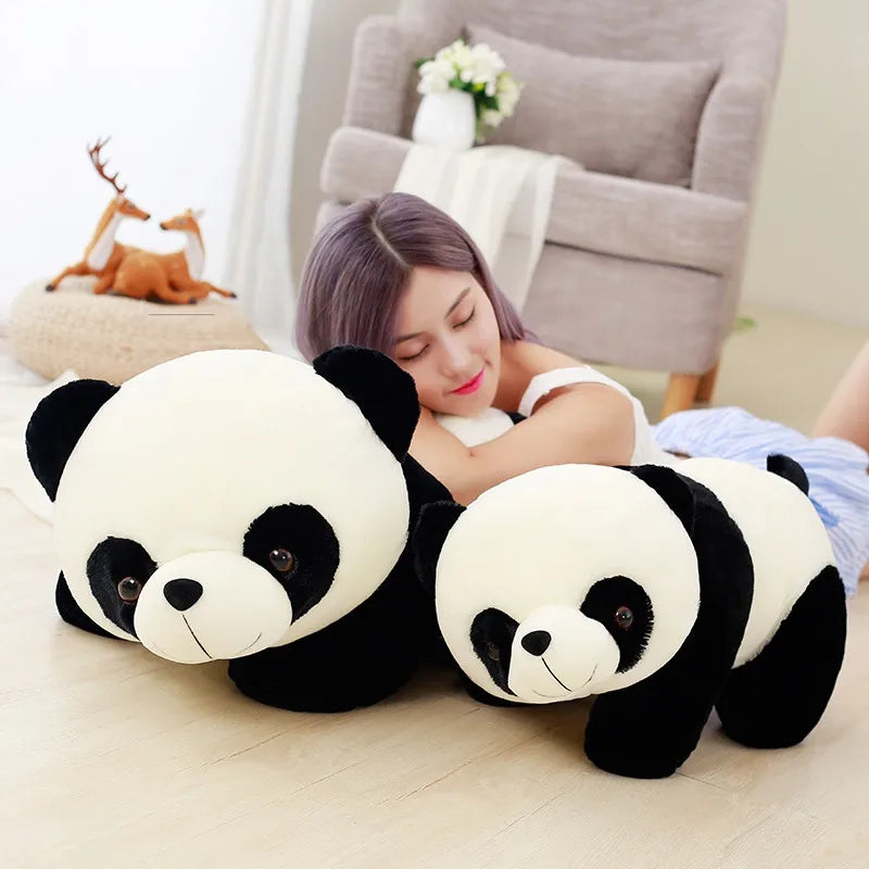 Person lying on the floor with two large panda kawaii plush toys in a cozy living room.