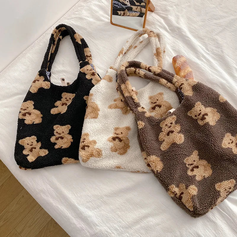 Three plush bags with kawaii teddy bear patterns on a white surface