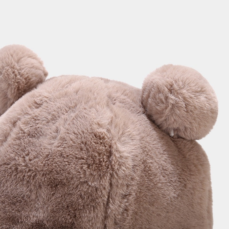 Close-up of a fluffy pink teddy bear Kawaii hat on a light gray background