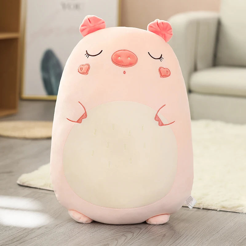 Plush kawaii toy shaped like a pig on a wooden floor