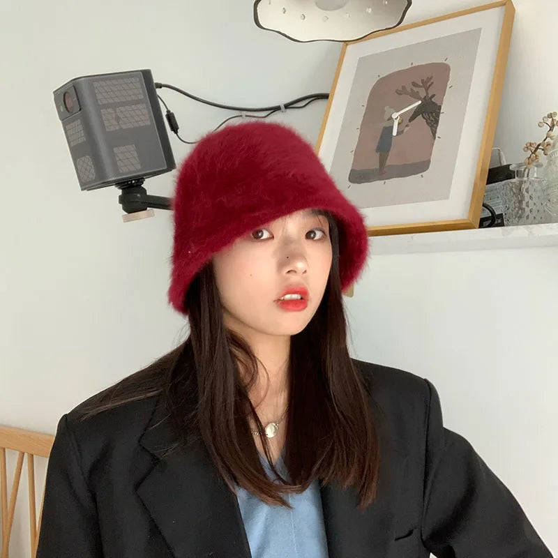 Person wearing a red Kawaii hat in an indoor setting with a camera and light equipment.