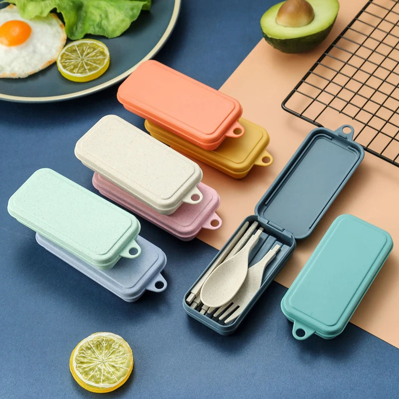 Set of colorful portable kawaii utensils cases with open case showing cutlery on a blue surface.