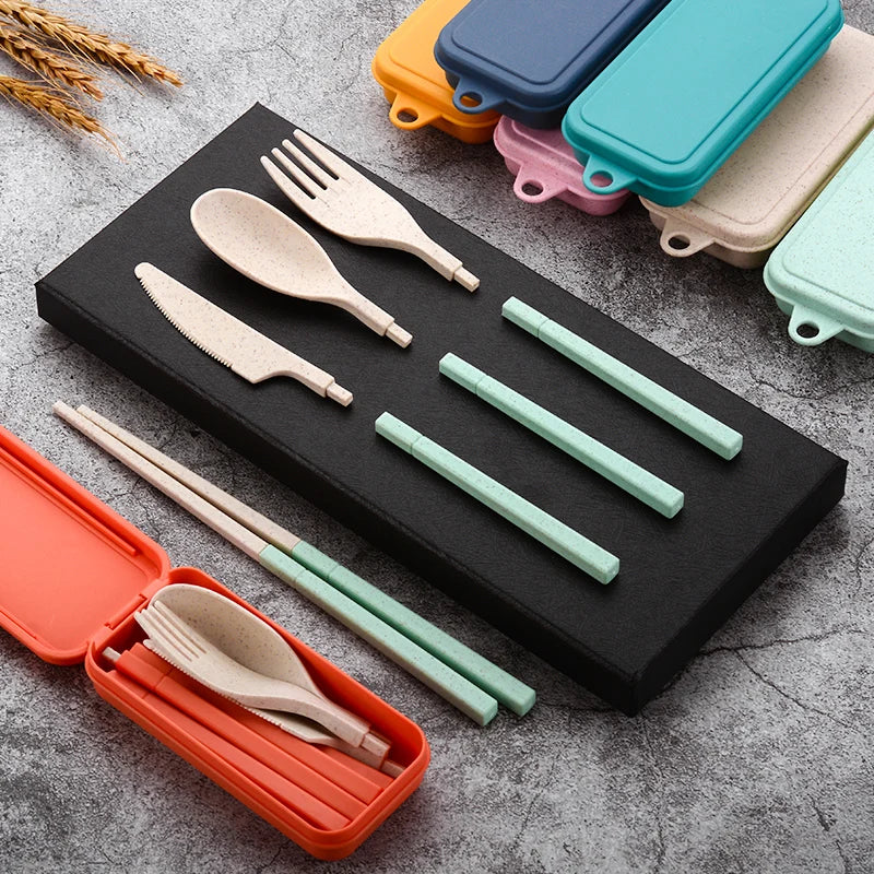 Set of reusable kawaii utensils and straws in a black case on a gray surface.