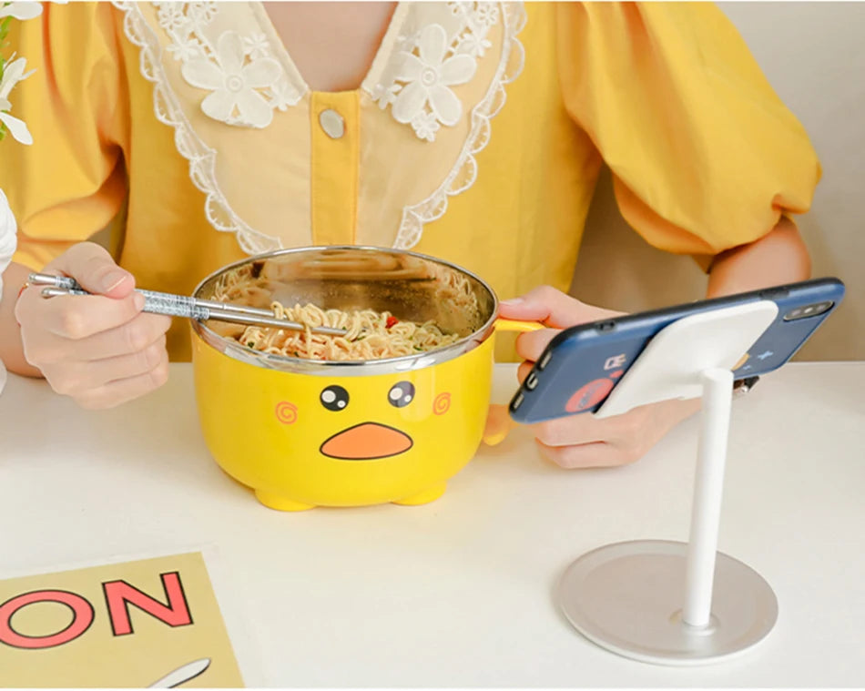 A woman eating out of a duck themed kawaii ramen bowl