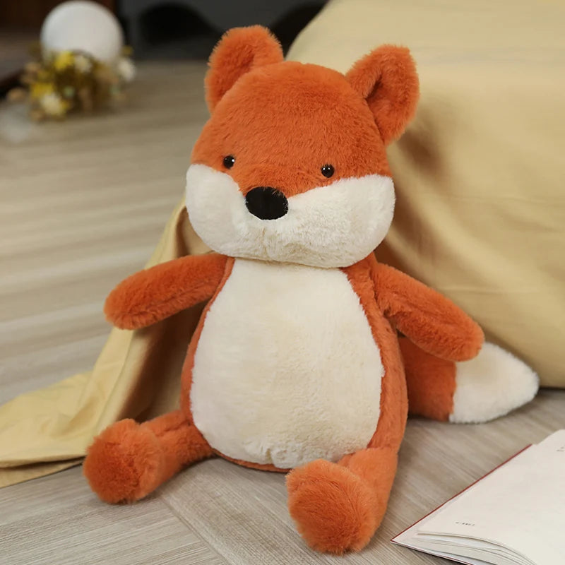 Kawaii plush fox toy on a wooden floor with a book and blanket in the background