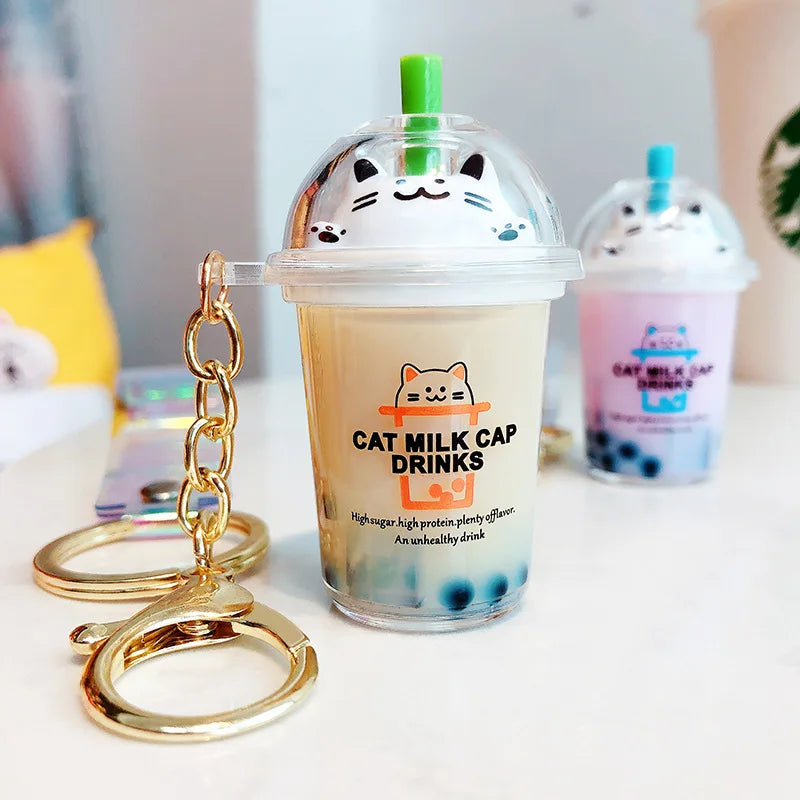 Cat kawaii milk cap drink keychain with a transparent cup design on a blurred background