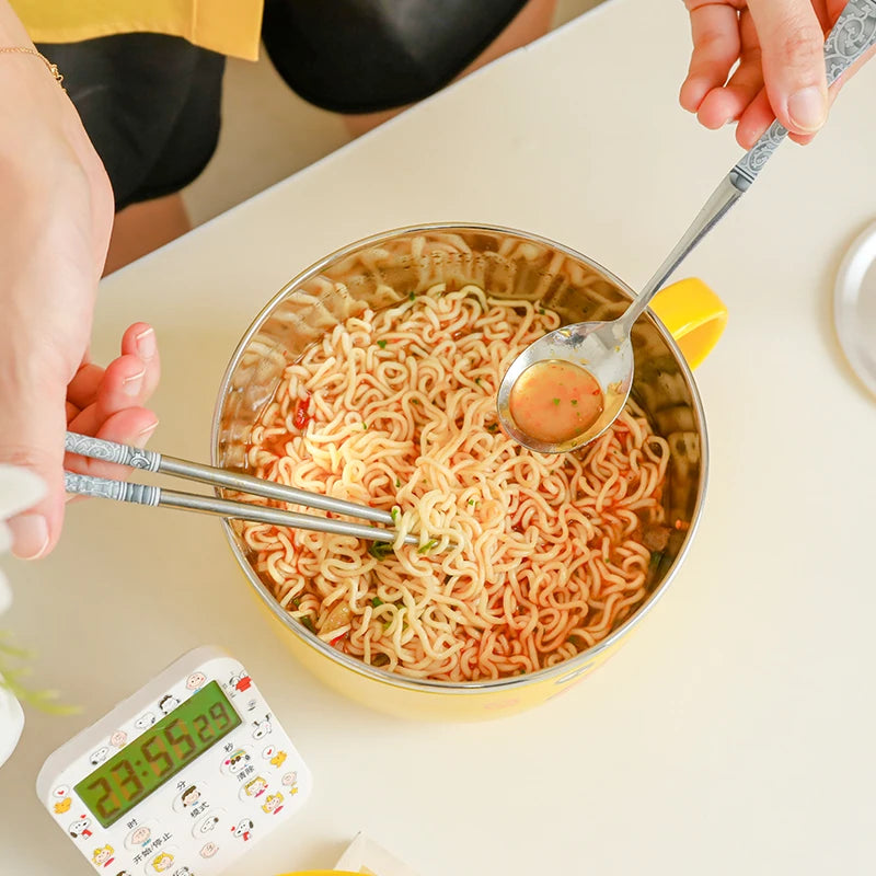 A close up of noodles inside a duck themed kawaii ramen bowl