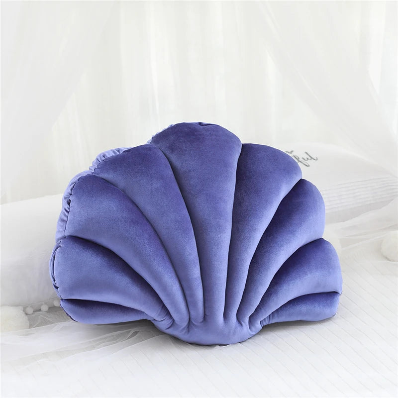 Purple shell-shaped kawaii pillow on a white background