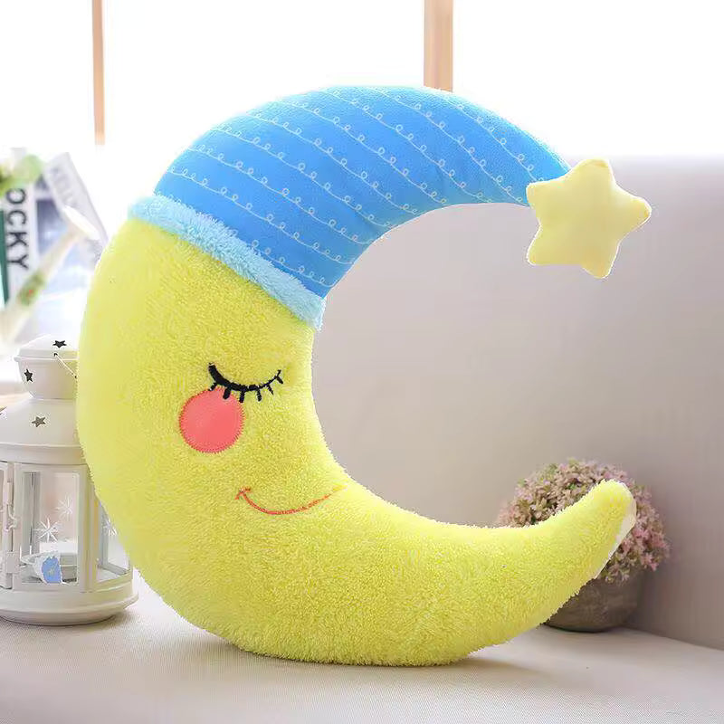 Kawaii plush moon-shaped toy with a smiling face on a white surface