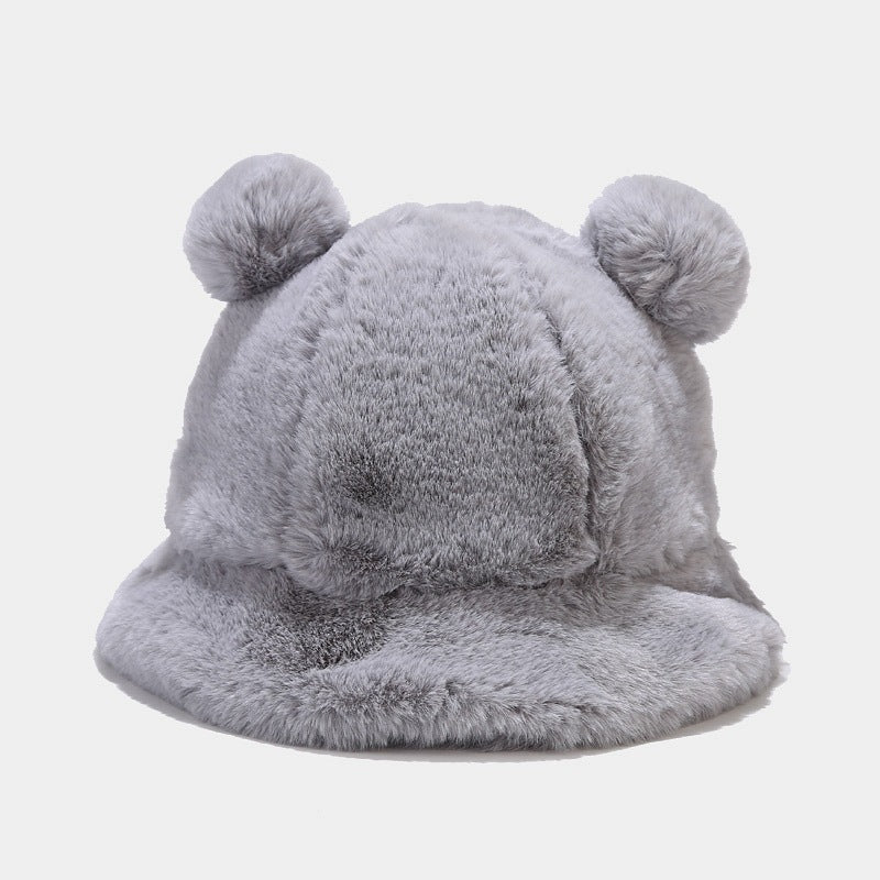 Gray fluffy Kawaii hat with pom-poms on a light gray background