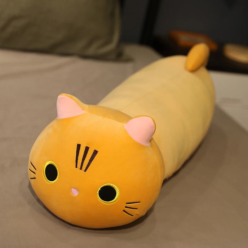Cat-shaped plush kawaii pillow on a bed