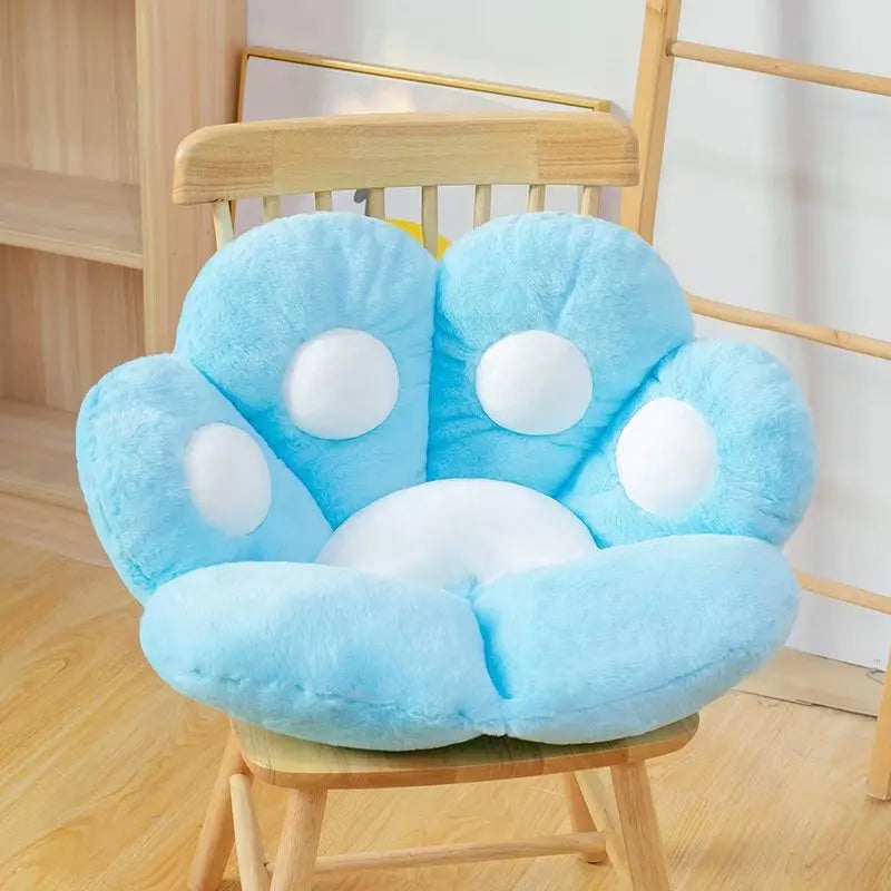 Blue paw-shaped kawaii cushion on a wooden chair