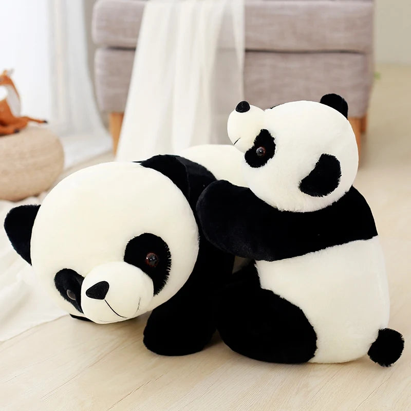 Two panda kawaii plush toys sitting on a light-colored floor.