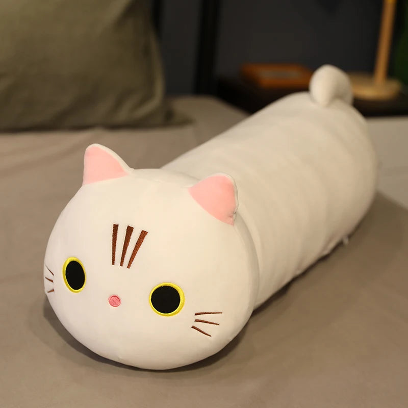 Cat-shaped kawaii plush pillow on a bed