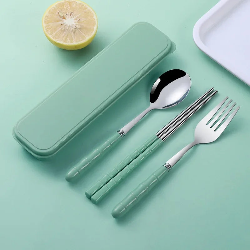 Set of silver kawaii utensils with green handles on a light green background