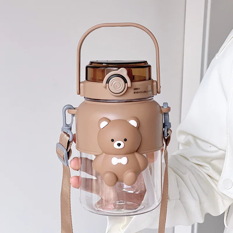 Clear kawaii water bottle with bear design and brown lid on a white background