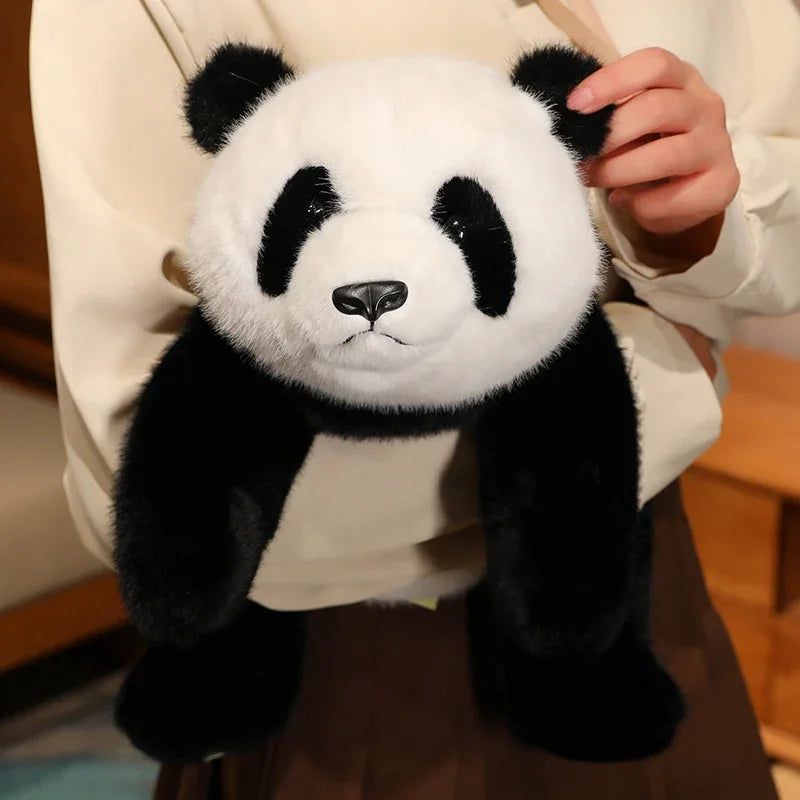 Kawaii plush panda held by a person wearing a white coat.