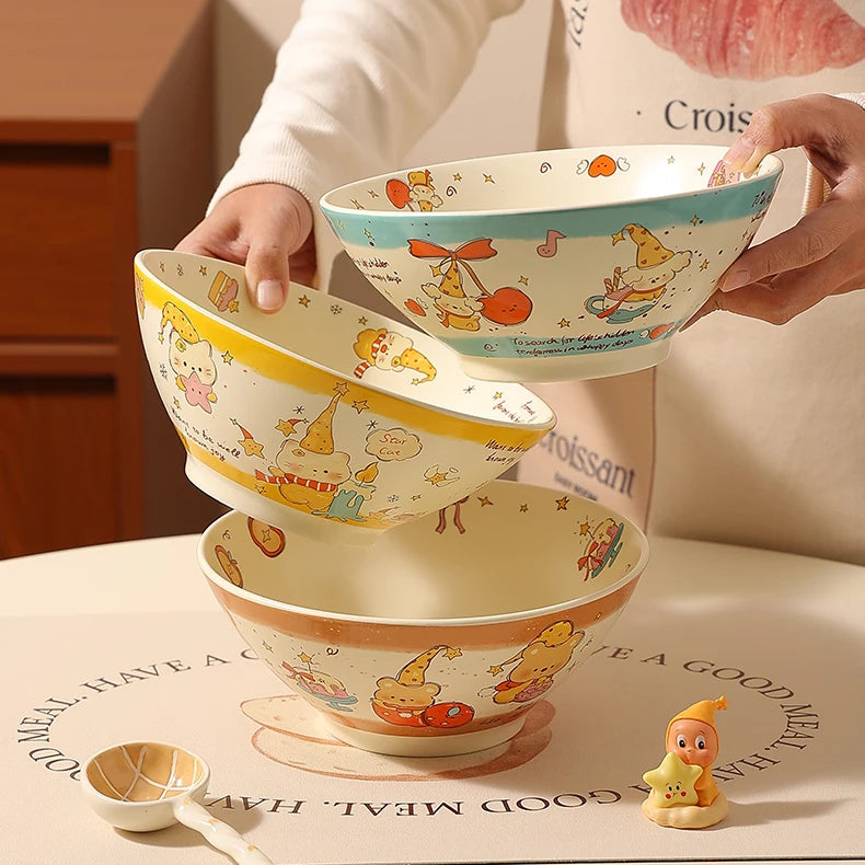 Set of three cartoon-themed ceramic kawaii ramen bowls being held by a person.