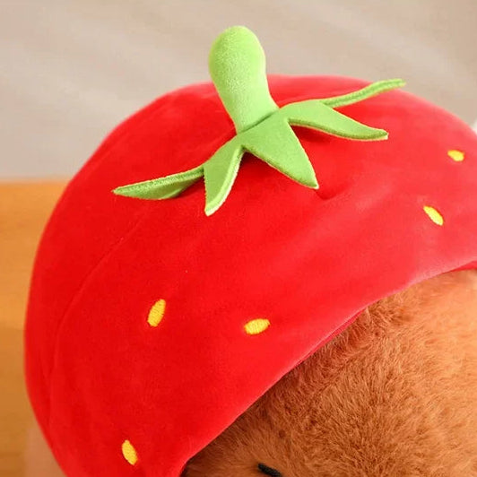 Kawaii plush toy with a strawberry-shaped hat on a plain background