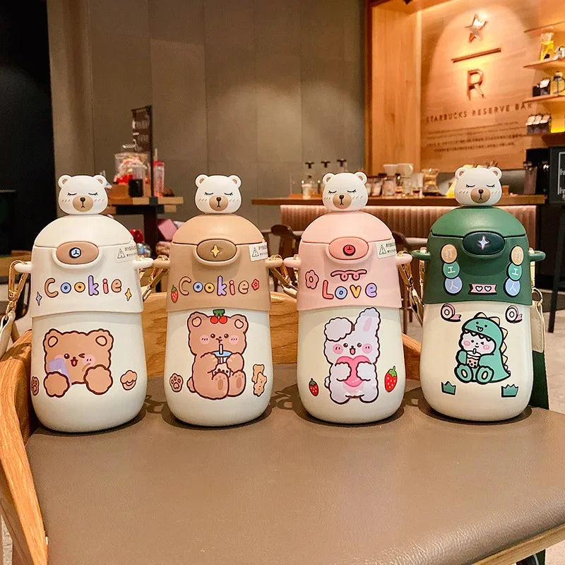 Four cute bear-themed kawaii cups on a table with a blurred cafe background