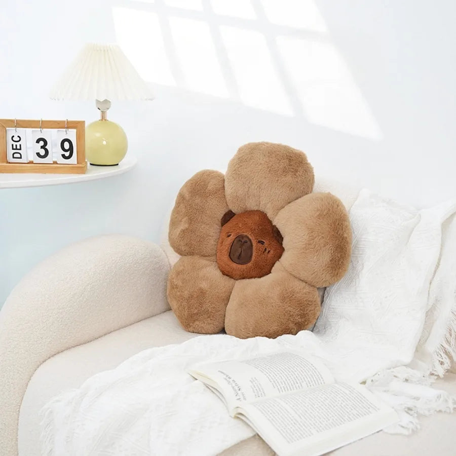 Flower-shaped brown kawaii pillow on a white couch with a light background