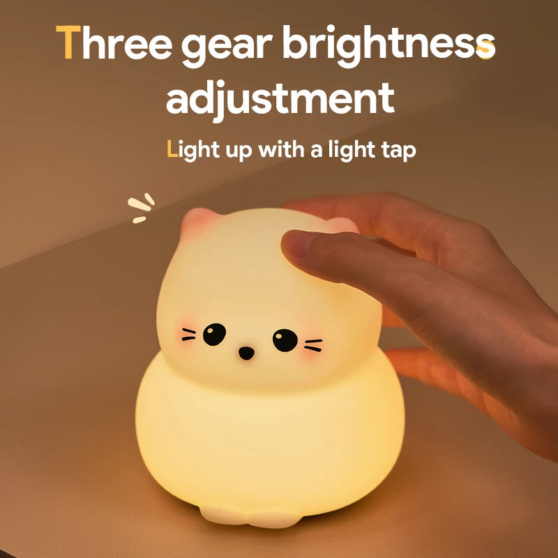 Cute kawaii animal-shaped night light with a hand tapping it on a brown background