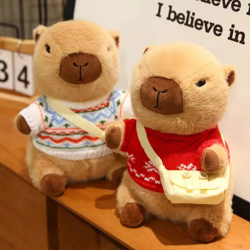 Two kawaii teddy bears wearing sweaters and small bags on a wooden surface.