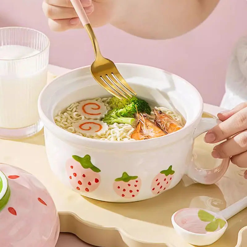 Someone eating from a white kawaii bowl with strawberries on it