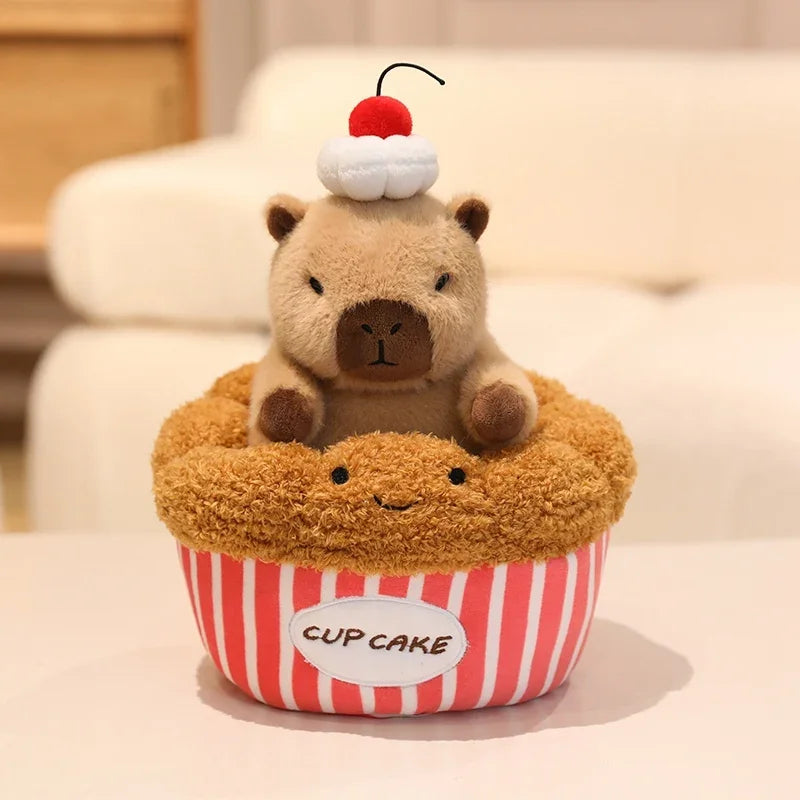 Kawaii plush toy bear in a cupcake with a cherry on top, sitting on a plush cupcake pillow.