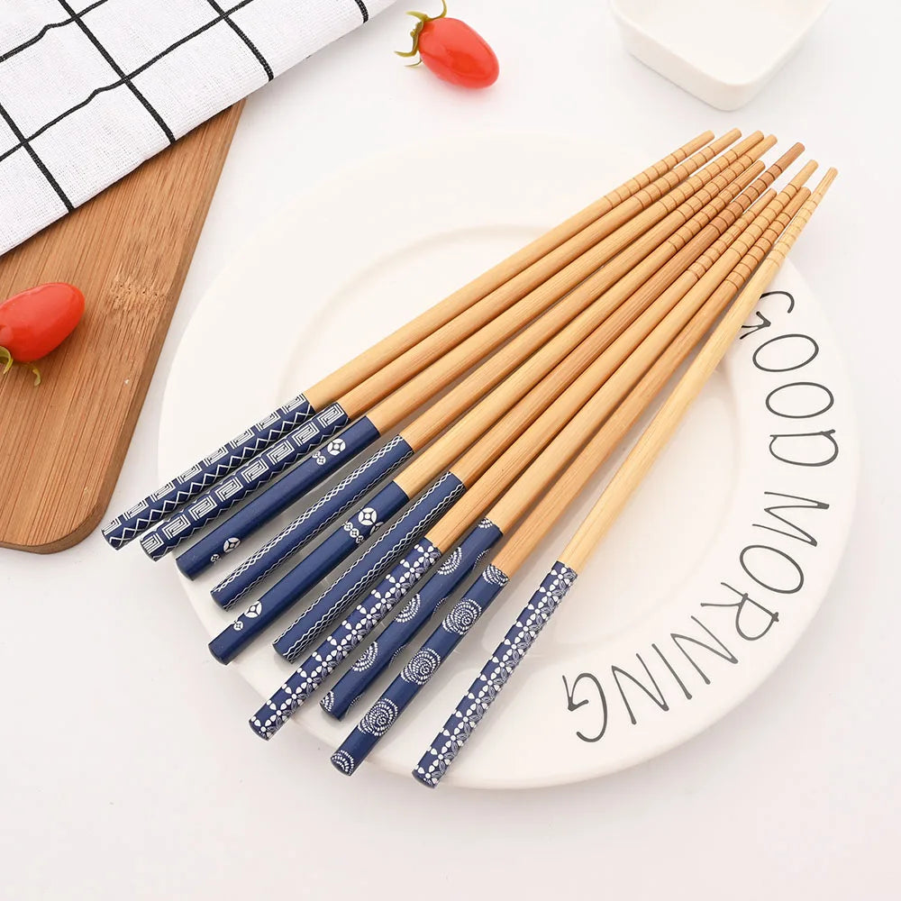 Set of wooden and blue patterned kawaii chopsticks on a white plate with 'Good Morning' text.