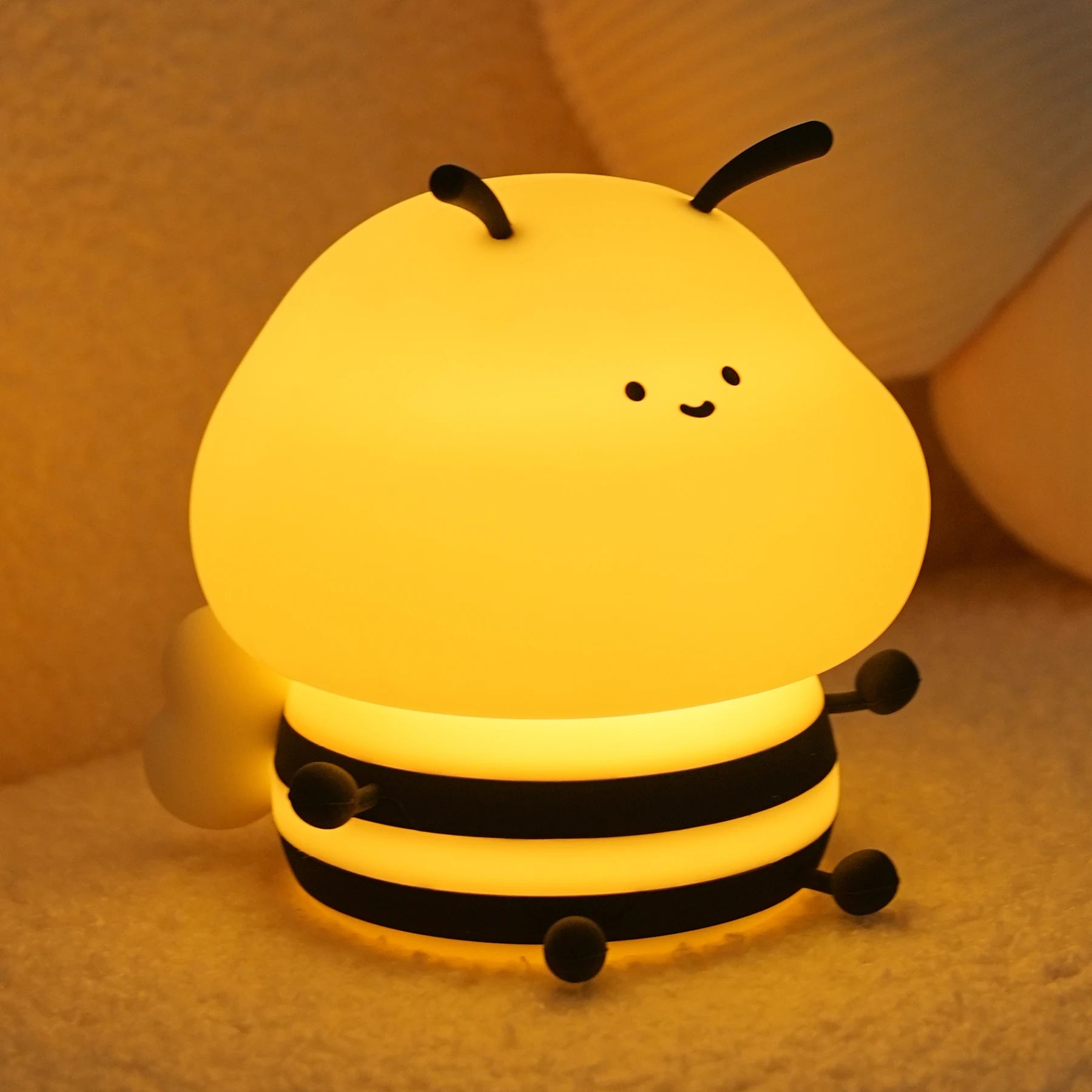 Cute bee-shaped kawaii night light emitting a warm glow.