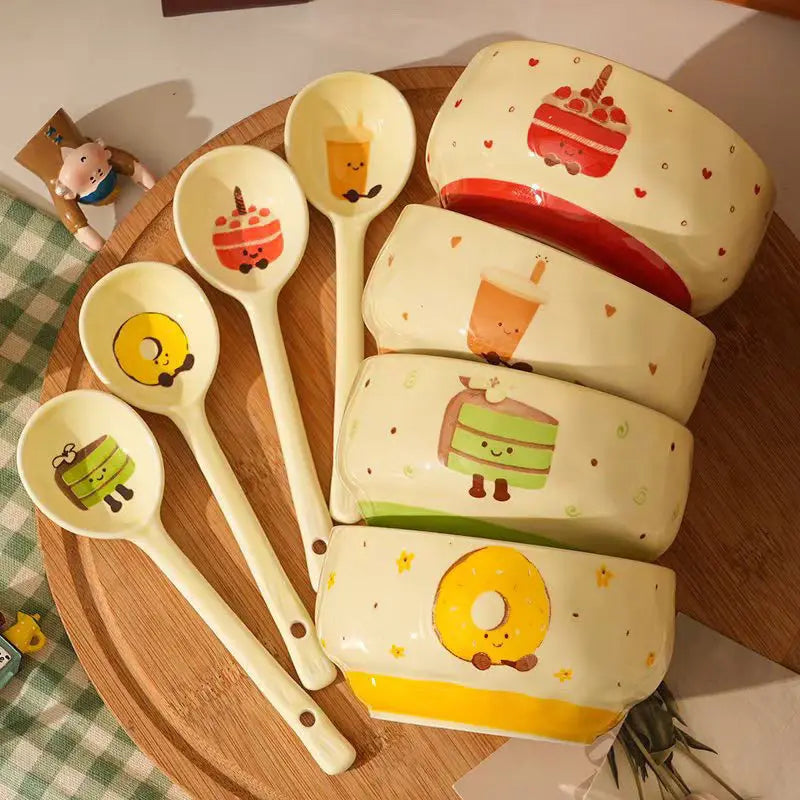 A group of four ramen bowls and spoons with cute character designs