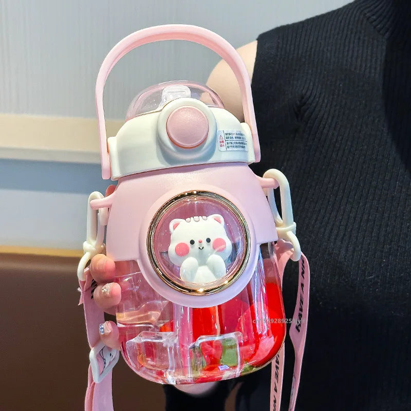 Pink kawaii water bottle with a bear design held by a person