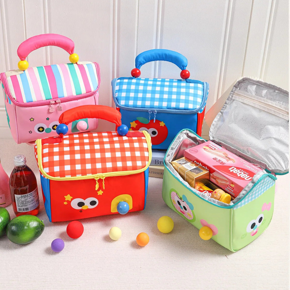 Colorful insulation kawaii bags with cartoon designs on a white background