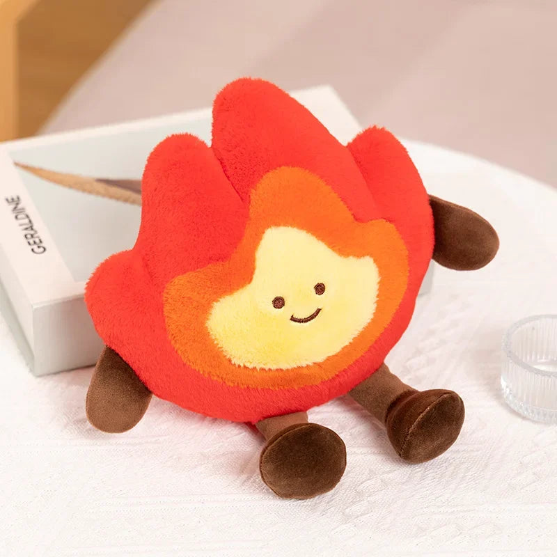 Kawaii plush toy shaped like a fire with a smiling face on a white surface.