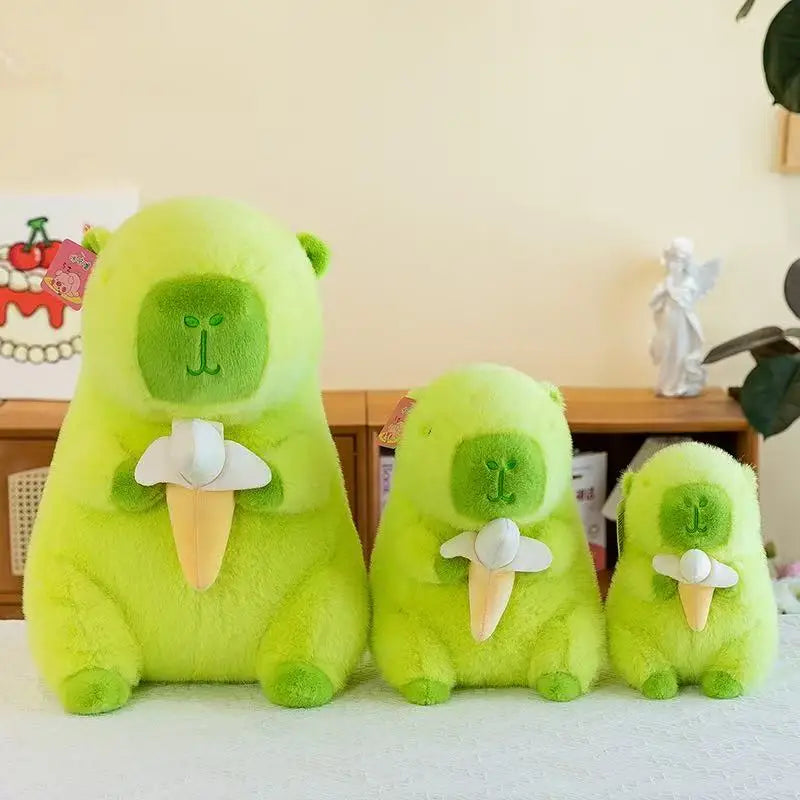 Three green kawaii plush toys resembling avocados on a white surface with a blurred background.