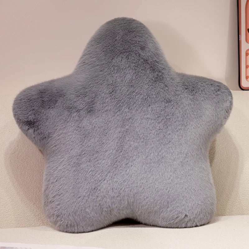 Star-shaped gray pillow on a light-colored couch