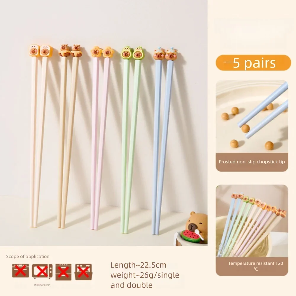 Set of colorful kawaii chopsticks with a stand on a light background