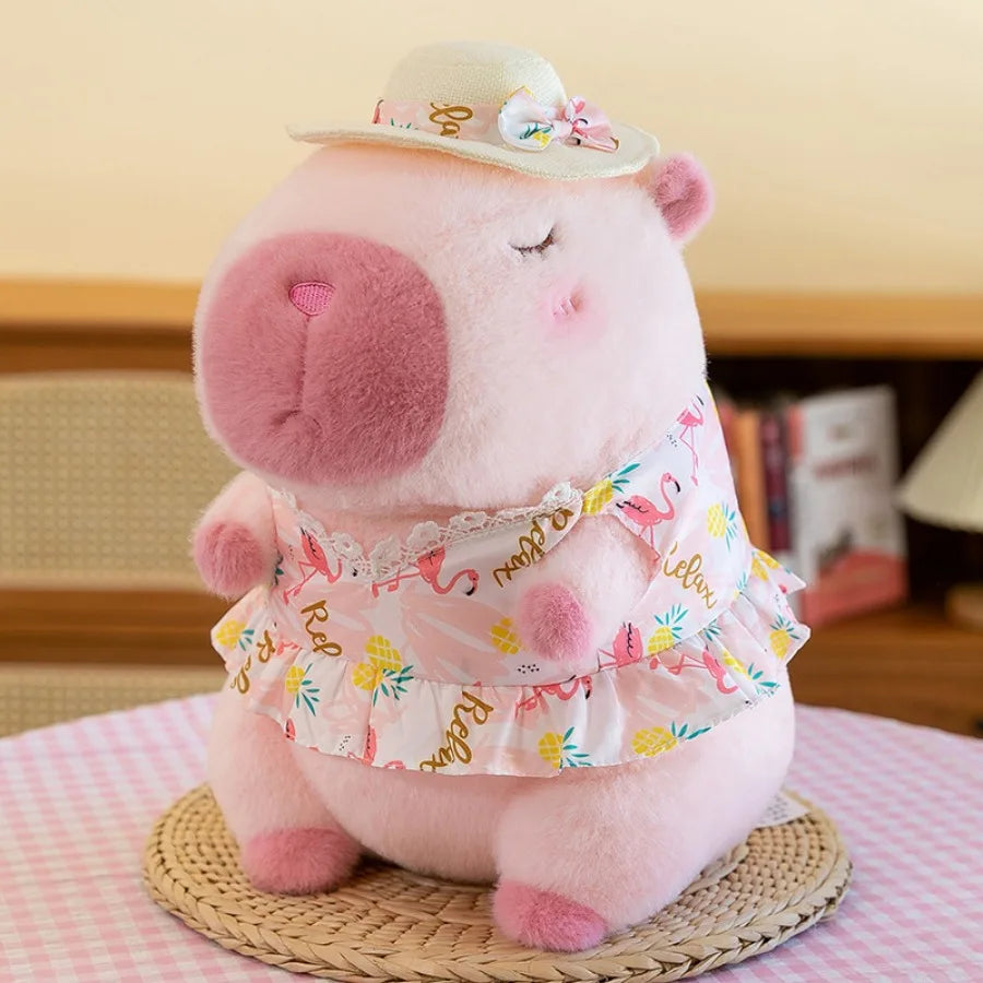 Kawaii plush toy hippo wearing a floral dress and hat on a pink checkered surface.