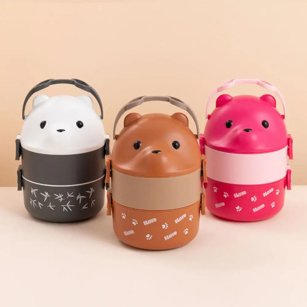 Three animal-themed kawaii lunch boxes in white, brown, and pink on a beige background