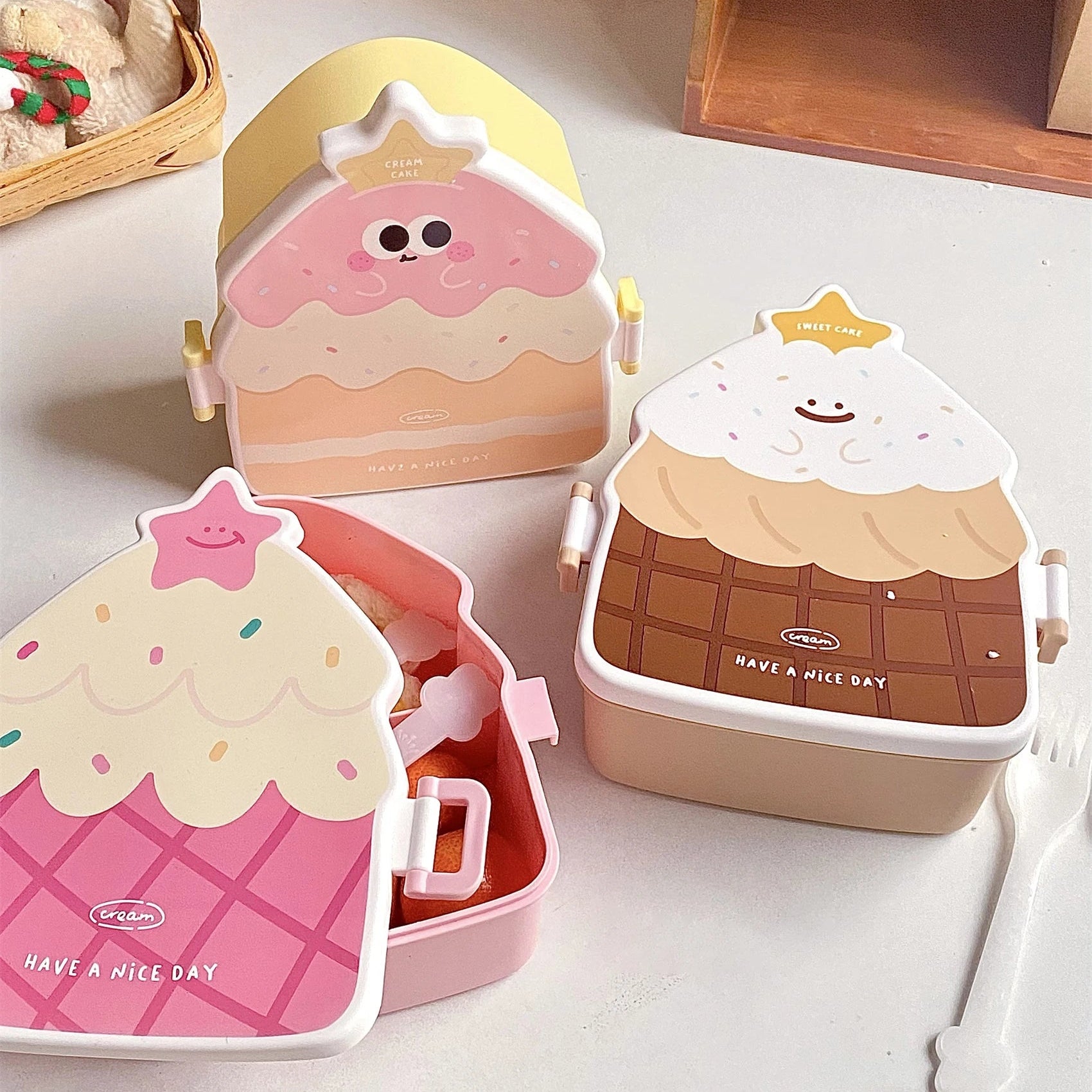 Set of four cute, cartoon-style kawaii bento boxes on a white surface with a wooden shelf in the background.