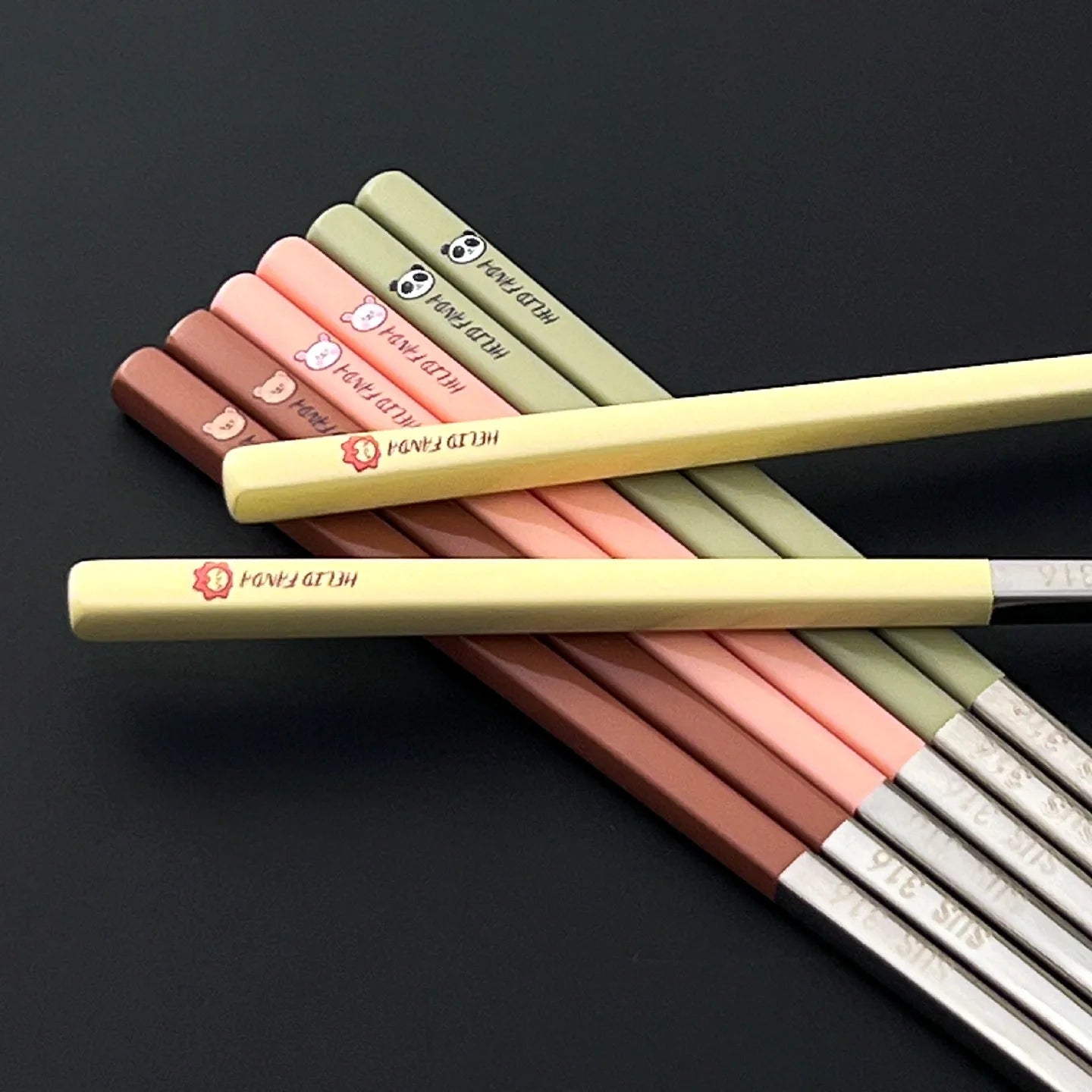 Set of colorful kawaii chopsticks with visible brand names on a black background