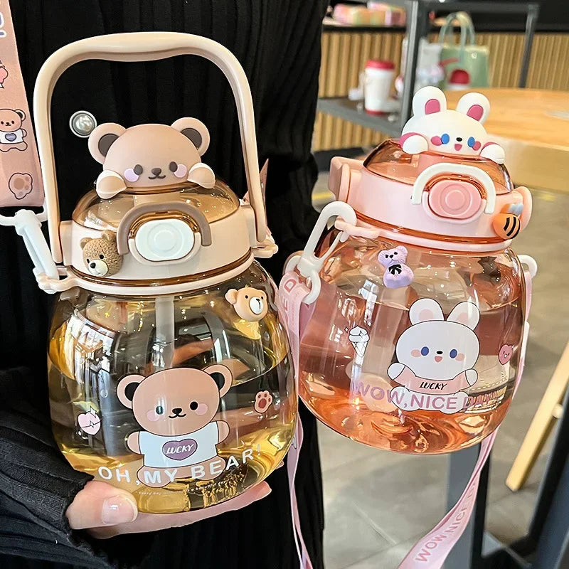Two cartoon-themed kawaii water bottles held by a person in an indoor setting.