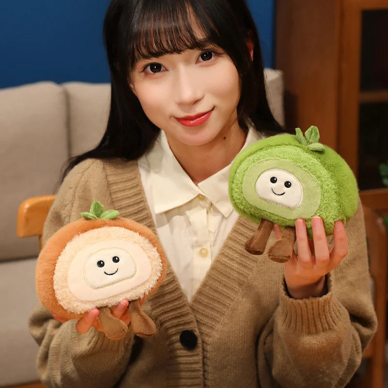Person holding two kawaii plush toys resembling green and brown round characters with a smiling face.