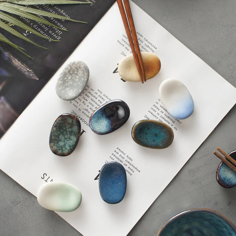 Set of ceramic kawaii chopstick holders with different textures and colors on a magazine page.