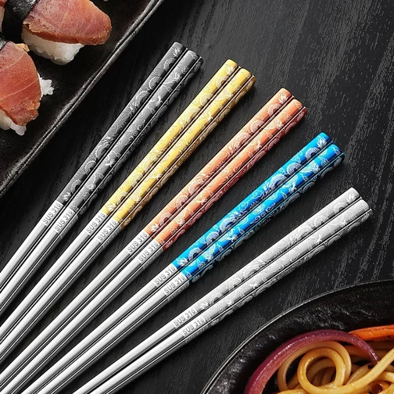 Set of colorful patterned kawaii chopsticks on a dark surface with sushi and noodles.