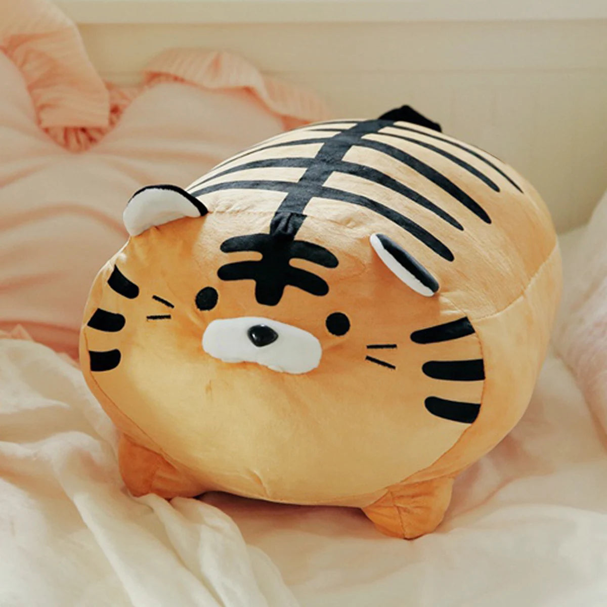 Kawaii plush tiger toy on a soft, light-colored surface
