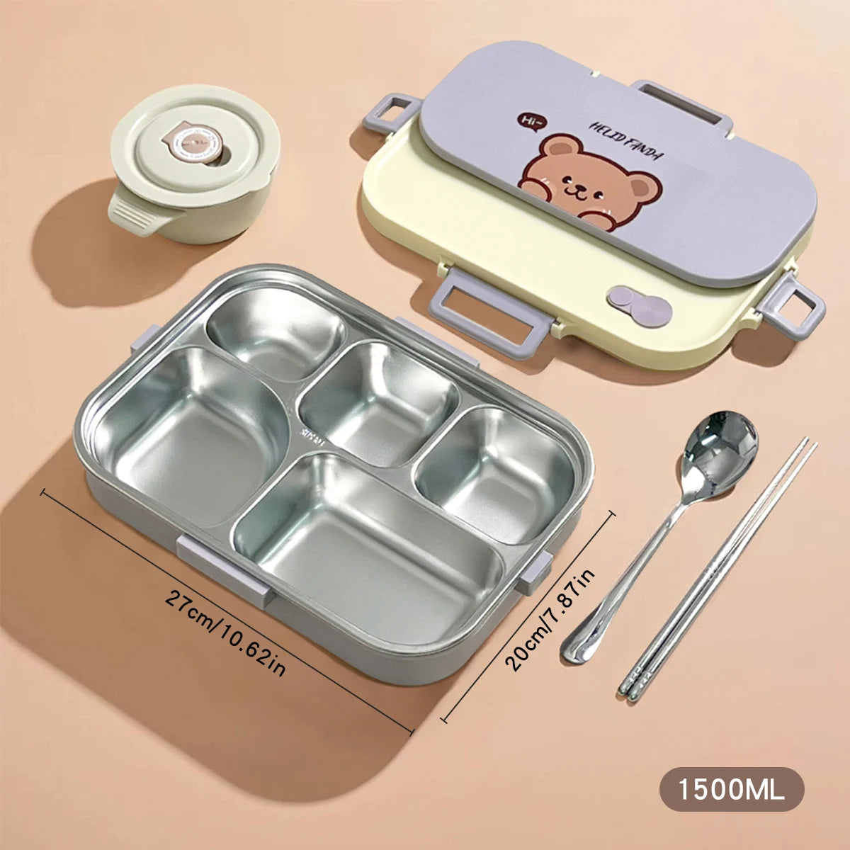 Stainless steel bento box with kawaii bear design lid, spoon, and chopsticks on a beige background